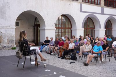 Ana Milek giving a talk in Monastery courtyard